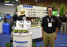 Hans Dramm of Dramm Corporation next to the Drammatic liquid fertiliser and in in front of their water accessories display.